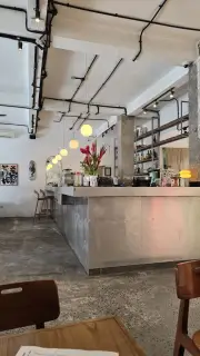 Modern Industrial Cafe Interior with Warm Lighting and Tropical Flowers