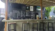 Vibrant Open-Air Bar at Bali Backpacker Hostel with Chalkboard Menu