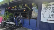 Vibrant Dog House Cafe Exterior in Bali with Scooters