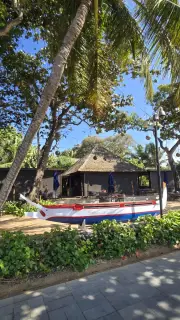 Tropical Bali Restaurant with Traditional Boat and Palm Trees