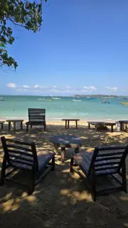 Relaxing Beach Chairs and Tables on Sunny Bali Shore