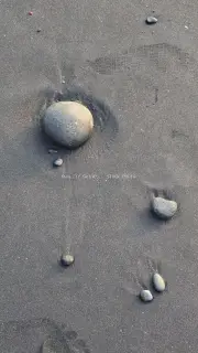 Black Sand Beach Texture with Smooth Pebbles, Natural Background