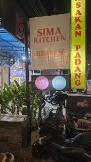 Sima Kitchen Restaurant Signage at Night in Bali, Indonesia