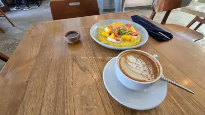 Healthy Tropical Breakfast and Coffee on Wooden Table in Bali Cafe - stock photo