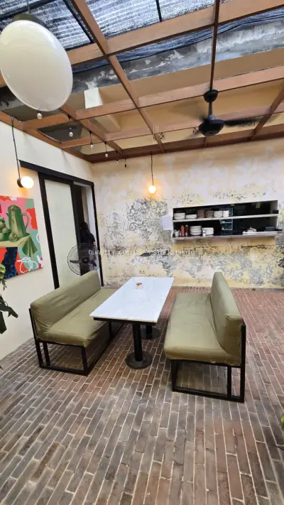 Rustic Cafe Interior with Distressed Walls and Brick Floor in Bali - stock photo