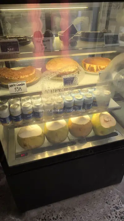 Bali Cafe Display Case with Desserts, Drinks, and Fresh Coconuts - stock photo