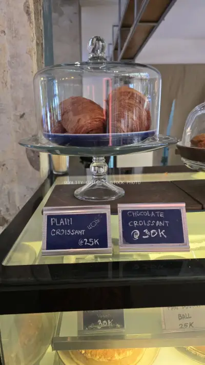 Freshly Baked Croissants Displayed in a Modern Bali Cafe Bakery - stock photo