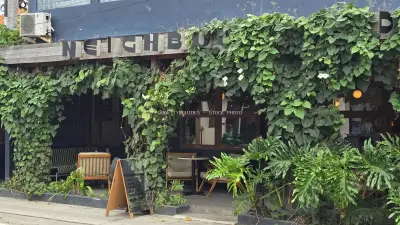 Lush Green Cafe Exterior in Bali with Inviting Outdoor Seating - stock photo