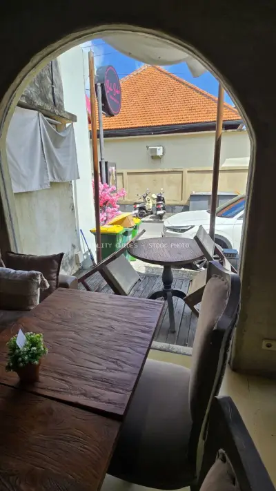 Bali Cafe Interior View with Street Scene and Bakery Sign - stock photo