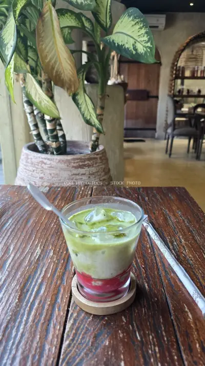 Refreshing Layered Matcha Drink on Wooden Table in Bali Cafe - stock photo