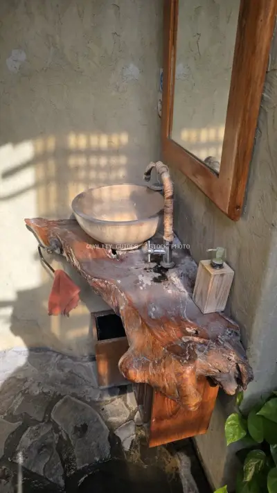 Rustic Outdoor Bathroom Sink with Natural Wood Countertop in Bali - stock photo