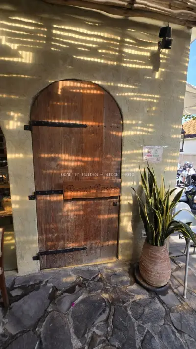 Rustic Wooden Door of Bread Basket Bakery in Sunny Bali - stock photo