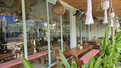 Cozy Balinese Cafe Interior with Tropical Decor and Natural Light - stock photo