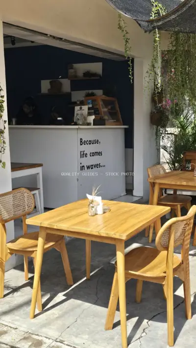 Bali Cafe Outdoor Seating with Inspiring Quote and Tropical Vibes - stock photo