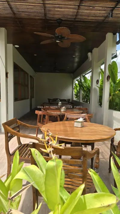 Tropical Bali Cafe Outdoor Dining Area with Wooden Furniture - stock photo