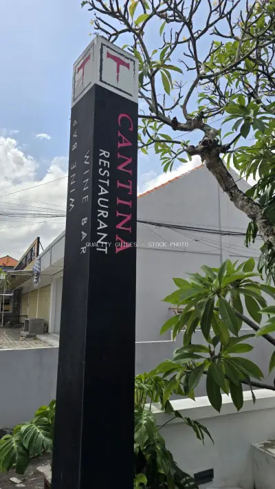 Cantina Restaurant Wine Bar Signpost in Sunny Canggu, Bali - stock photo