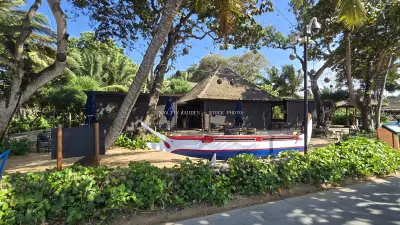 Fisherman's Club Bali: Tropical Beachfront Restaurant with Traditional Boat - stock photo
