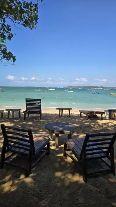 Relaxing Beach Chairs and Tables on Sunny Bali Shore - stock photo