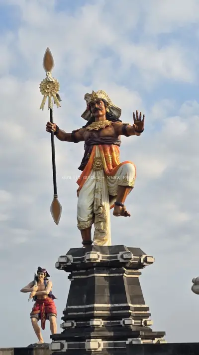 Majestic Balinese Warrior Statue Against Blue Sky in Seseh Beach Area - stock photo