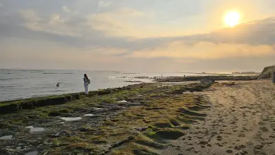 Serene Sunset at Cemagi Beach, Bali with People Enjoying the View - stock photo