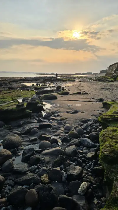 Serene Sunset at Cemagi Beach, Bali with Rocky Shoreline - stock photo