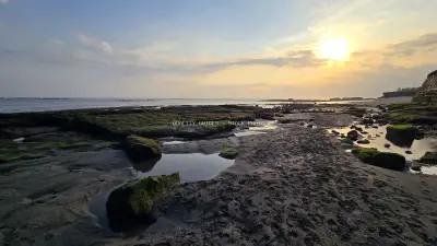 Golden Sunset over Rocky Cemagi Beach, Bali Coastline Landscape - stock photo