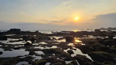Golden Sunset over Rocky Cemagi Beach in Bali - stock photo