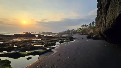 Golden Sunset over Cemagi Beach, Bali with Volcanic Rocks - stock photo