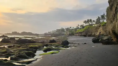 Serene Sunset at Cemagi Beach, Bali with Rocky Coastline - stock photo