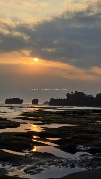 Golden Sunset over Tanah Lot Temple and Rocky Bali Coastline - stock photo