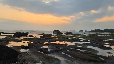 Dramatic Sunset Over Mengening Beach Bali with Rocky Tide Pools - stock photo