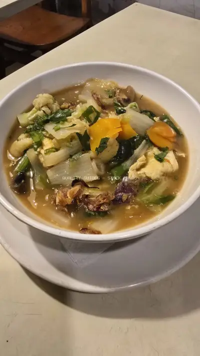 Delicious Indonesian Vegetable Soup with Tofu and Fresh Herbs - stock photo