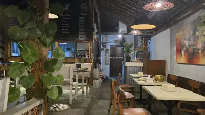 Rustic Balinese Restaurant Interior with Tropical Plants and Warm Lighting - stock photo