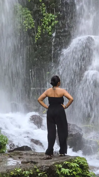 Woman Admiring Banyu Wana Amertha Waterfall Bali Indonesia - stock photo