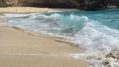 Turquoise Waves Crashing on Kelingking Beach Bali - stock photo