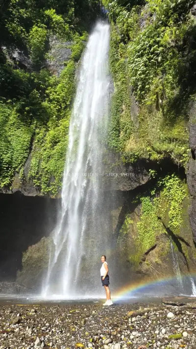 Traveler at Pucak Manik Waterfall Bali with Rainbow - stock photo