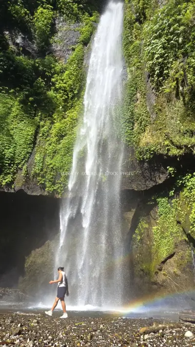 Shirtless Traveler at Tropical Waterfall Bali Indonesia - stock photo