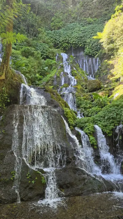 Cascading Waterfall in Lush Tropical Rainforest Bali - stock photo