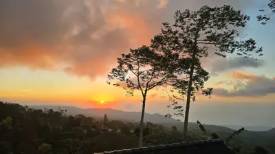 Tropical Sunset Over Bali Mountains and Forest Landscape - stock photo