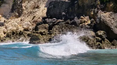 Dramatic Wave Crashing Rocky Cliffs Diamond Beach Bali - stock photo