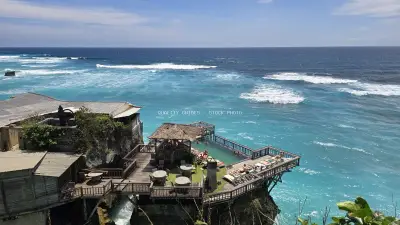Suluban Beach Clifftop Resort with Turquoise Ocean Waves - stock photo