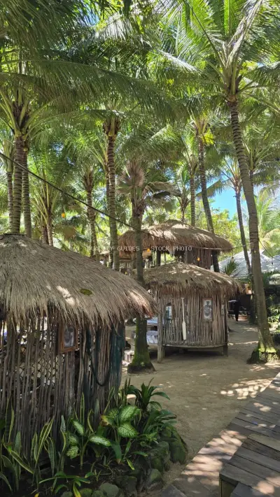 Tropical Beach Club Bali with Thatched Roof Bungalows - stock photo