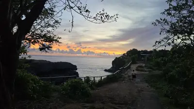 Broken Beach Bali Sunset with Tropical Vegetation - stock photo