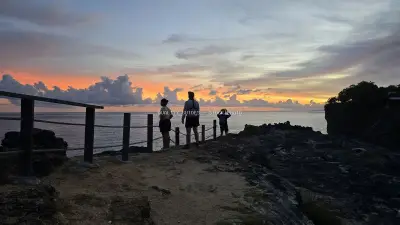Tourists at Broken Beach Bali Sunset Viewpoint - stock photo
