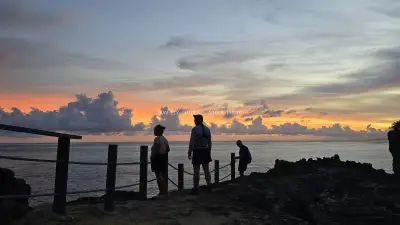 Tourists at Broken Beach Bali Sunset Viewpoint - stock photo