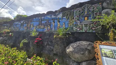 Balinese Temple Wall Art with Tropical Garden Flowers - stock photo