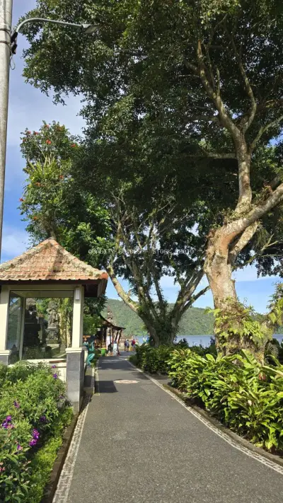 Ulun Danu Beratan Temple pathway with ancient tree Bali - stock photo
