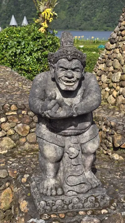 Balinese Stone Statue at Ulun Danu Beratan Temple Lake - stock photo