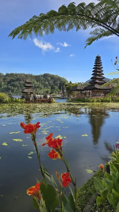 Ulun Danu Beratan Temple Bali with Red Flowers and Lake - stock photo