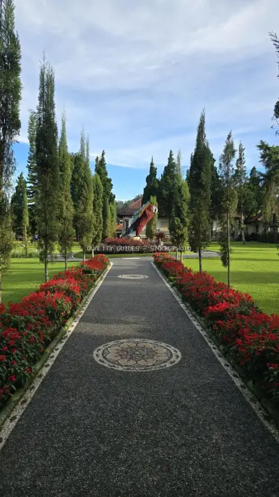 Ulun Danu Beratan Temple Bali Pathway with Red Flowers - stock photo